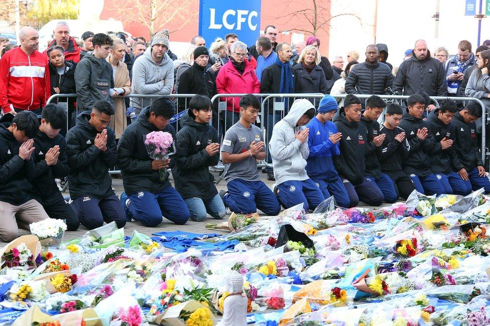 Players of the Fox Hunt Football Academy from Chaiyaphum in Thailand arrive to pay their respects outside the King Power stadium in Leicester, Britain, 28 October 2018