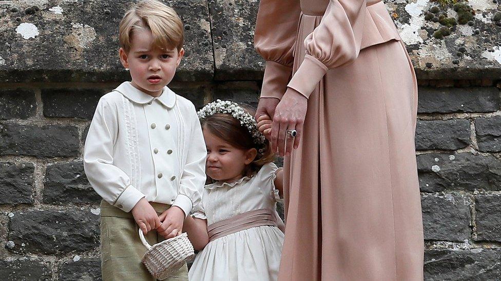 prince George and princess Charlotte stand with their mother, the Duchess of Cambridge.