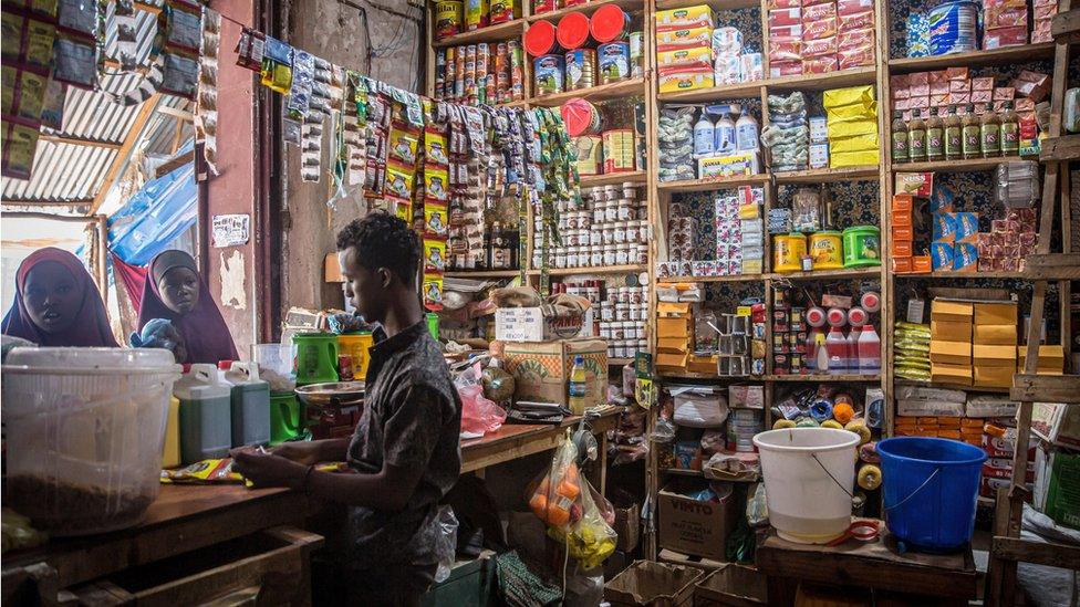 Customers shop at a store in Dollow, Jubaland, Somalia, where prices have risen significantly. People from across Gedo in Somalia have been displaced due to drought conditions and forced to come to Dollow, in the southwest, to search for aid. Somalia has suffered three failed rainy seasons in a row, making this the worst drought in decades, and 6 million people are in crisis levels of food insecurity. The problems are being compounded by the rising costs of food prices because of the Ukraine war. Hence, hundreds of thousands of livestock have died from hunger and thirst.