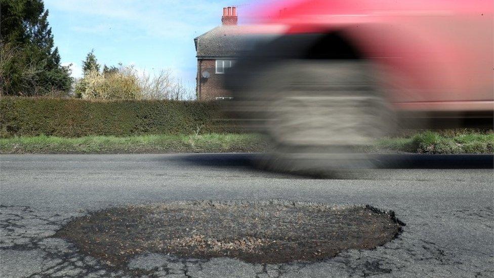 Pothole and vehicle