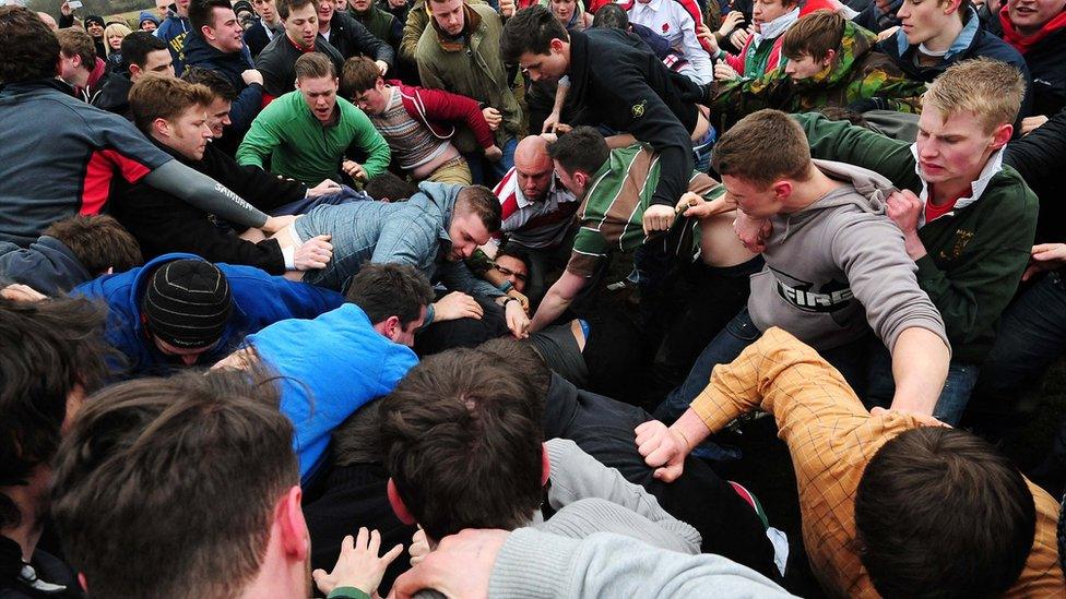 Thick of the action in the bottle kicking match