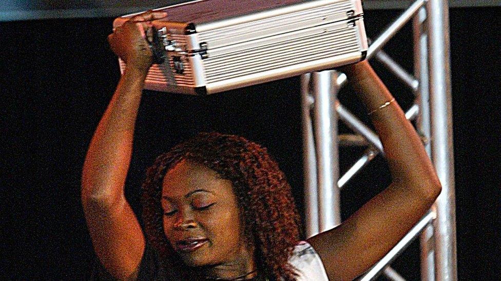 Cherise Makubale, 24, dances with a briefcase containing around £76,000 after winning Big Brother Africa in 2003.