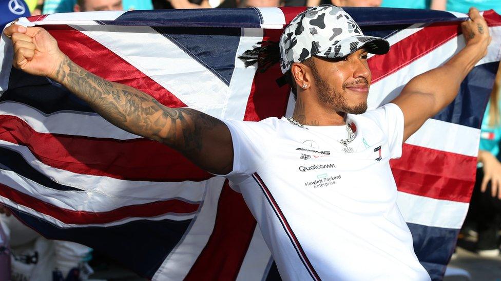 Lewis Hamilton celebrating his win with the Union Jack.