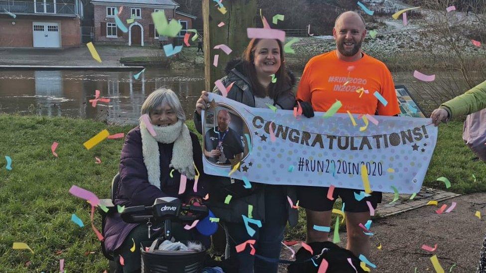 Chris at the finish line with his mother-in-law Carol and wife Rachel