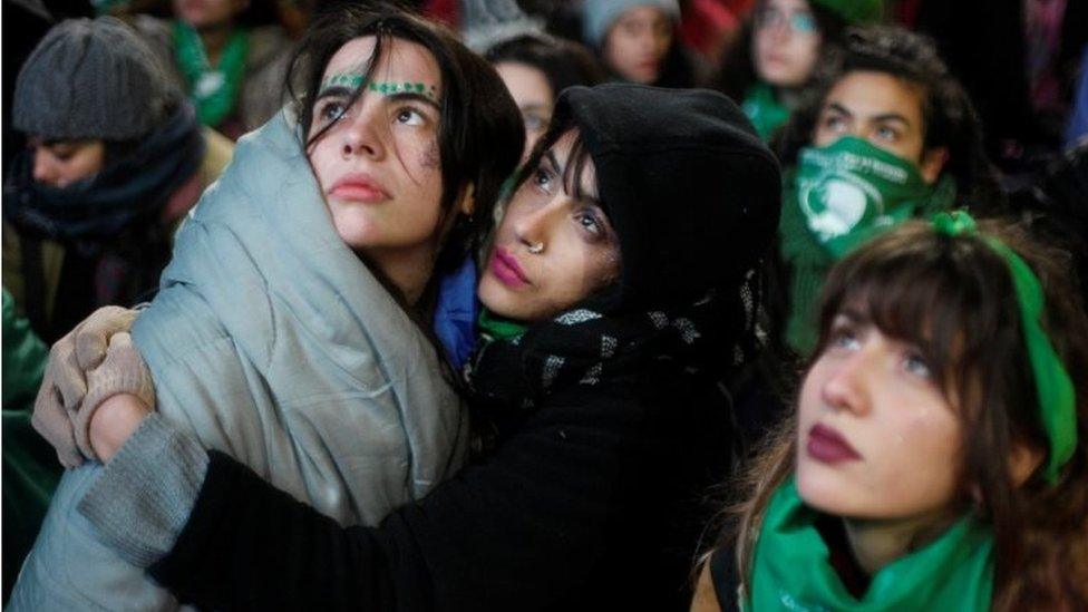 Two women hold each other as they wait for the vote result outside the Congress