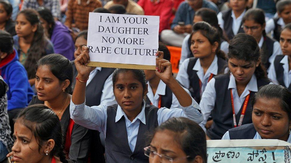 A woman holds a placard during a protest against the alleged rape and murder of a 27-year-old woman in Hyderabad, India, December 2, 2019