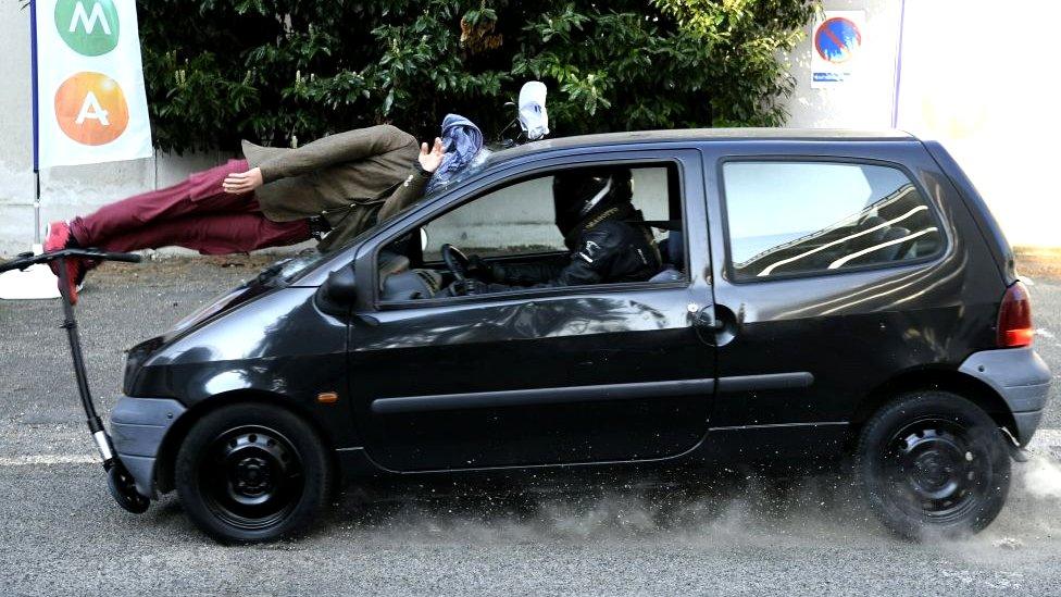 A car collides with a mannequin on an electric scooter during a crash test in Paris, France, 12 April 2019