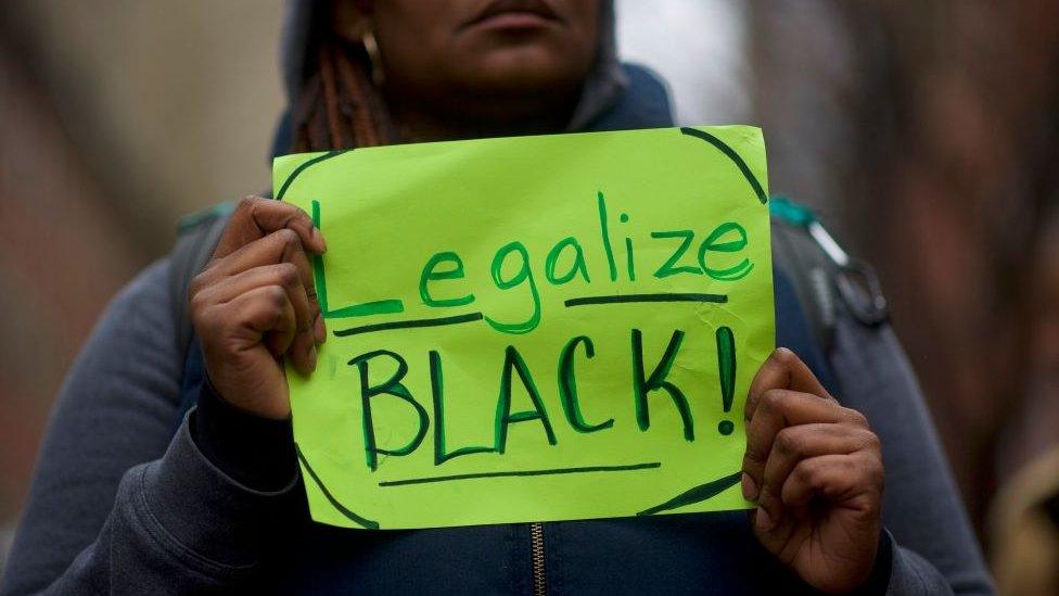 protester holds a sign