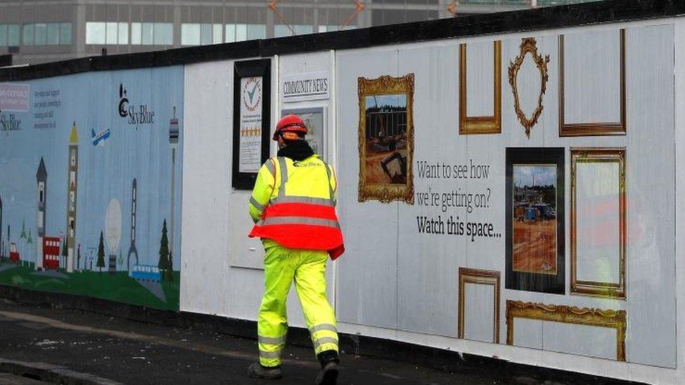 A worker walks into Carillion"s Midland Metropolitan Hospital construction site in Smethwick,