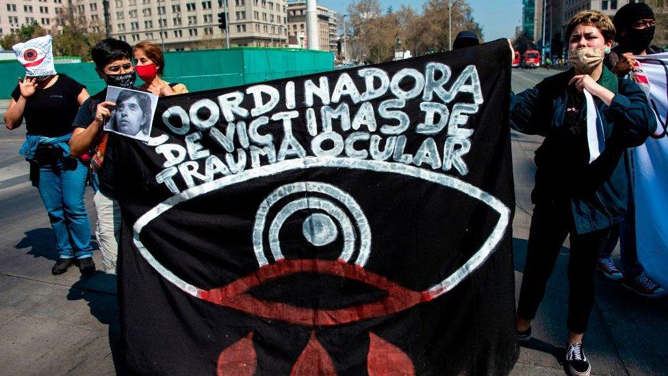 People protest for demonstrators who were hit in the eyes by police pellets outside La Moneda presidential palace in Santiago, on September 16, 2020.