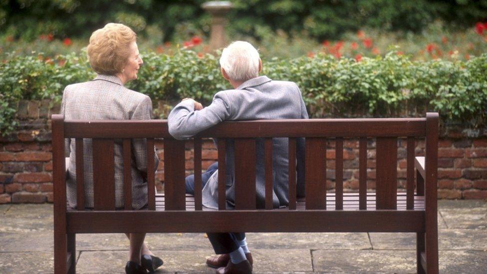 Margaret Thatcher sits on a bench with her husband, Denis at Chequers