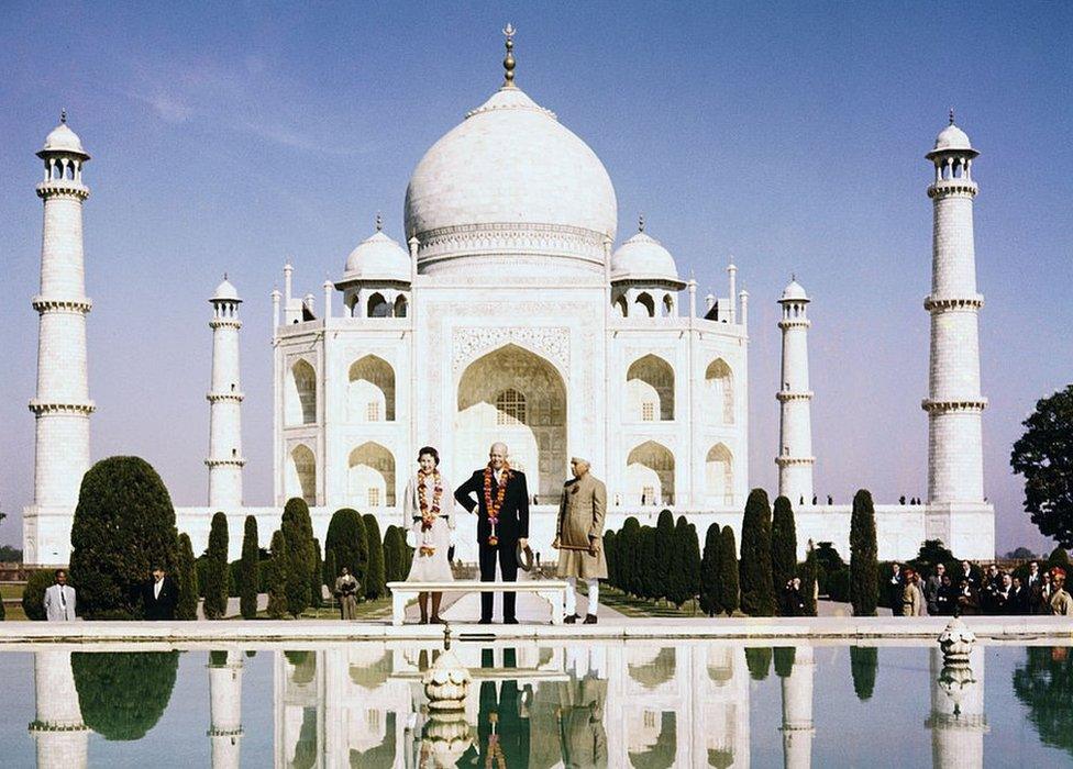 President Eisenhower, daughter-in-law Barbara, and Indian Prime Minister Jawaharlal Nehru (right) stand before the famed Taj Mahal, their images reflected in the pond at their feet