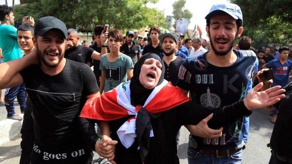 An Iraqi woman grieves for a relative killed in an IS-claimed suicide attack, 5 July