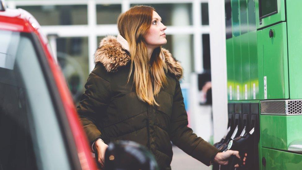 Woman filling up car