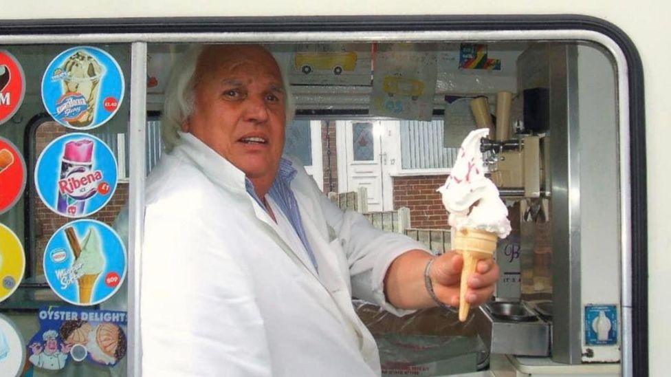 Image of Mr Rossi serving an ice cream in his van