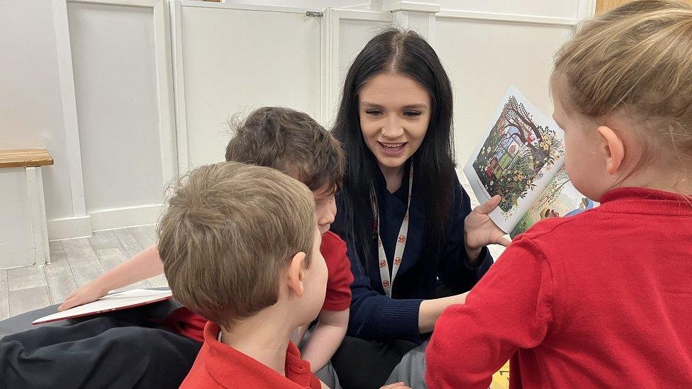 Luci Rickard reading a story to children