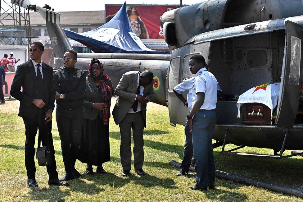 People waiting near the helicopter