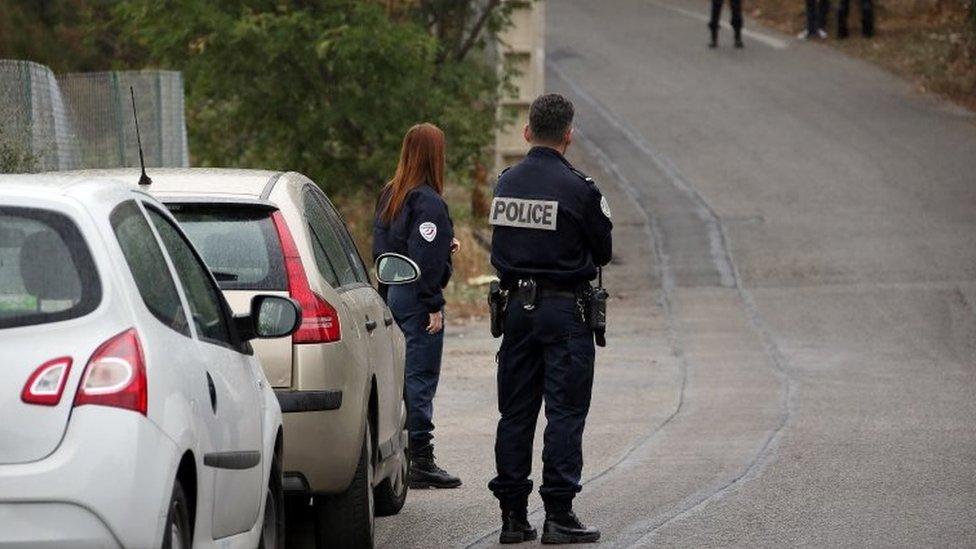 French police officers stand at the scene where Jacqueline Veyrac was found alive two days after being kidnapped