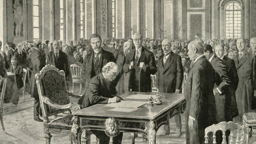 The prime minister of Britain signing the Versailles Treaty in June 1919