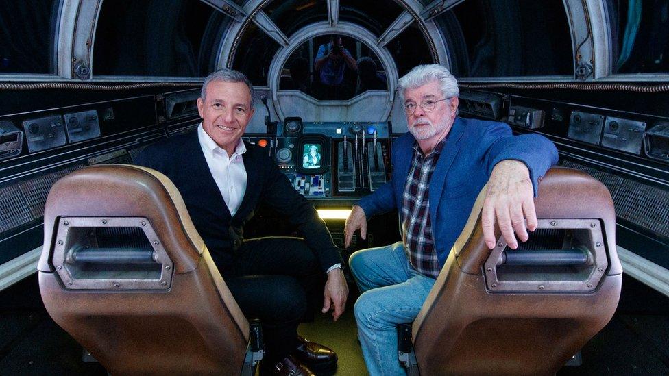 Bob Iger (left) and Star Wars creator George Lucas inside Millennium Falcon: Smugglers Run at Star Wars: Galaxy's Edge at Disneyland Park in California