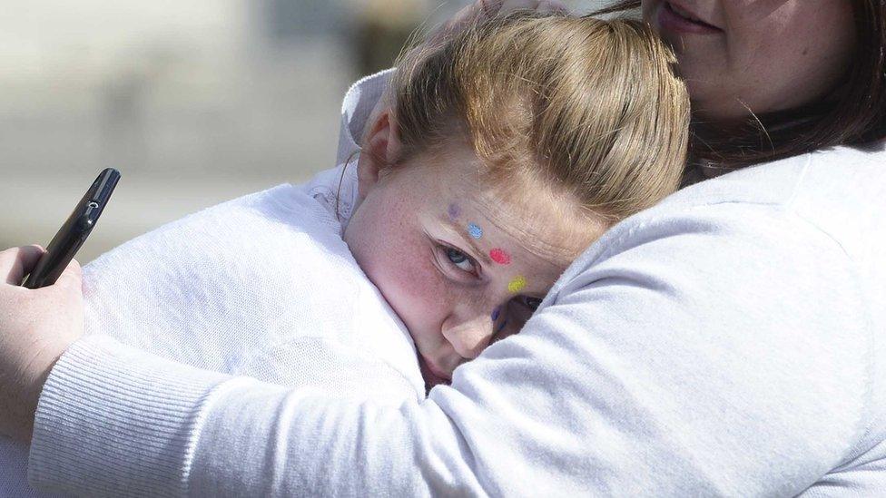 Children were comforted by parents outside the SSE Arena when the announcement was made