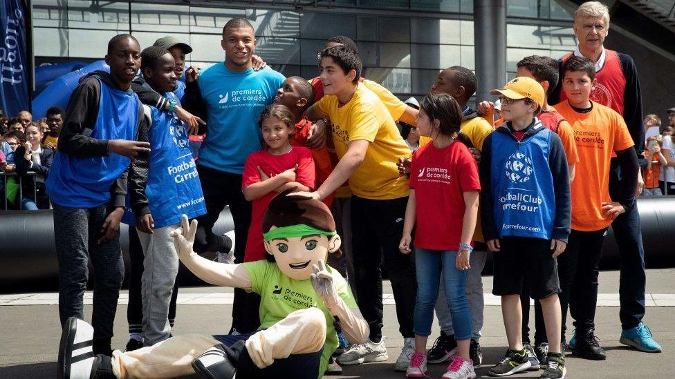 Kylian Mbappe with children