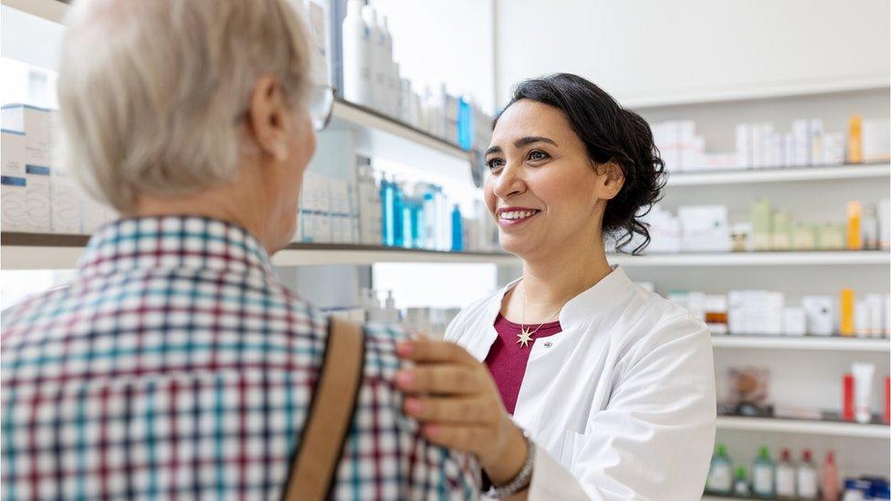 A pharmacist with an elderly patient