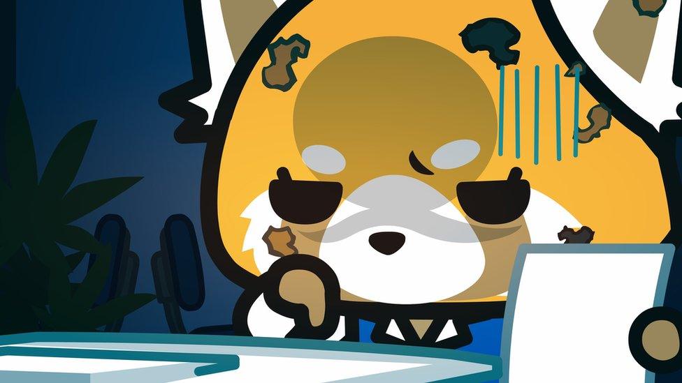 Aggretsuko, looking sad at her desk.