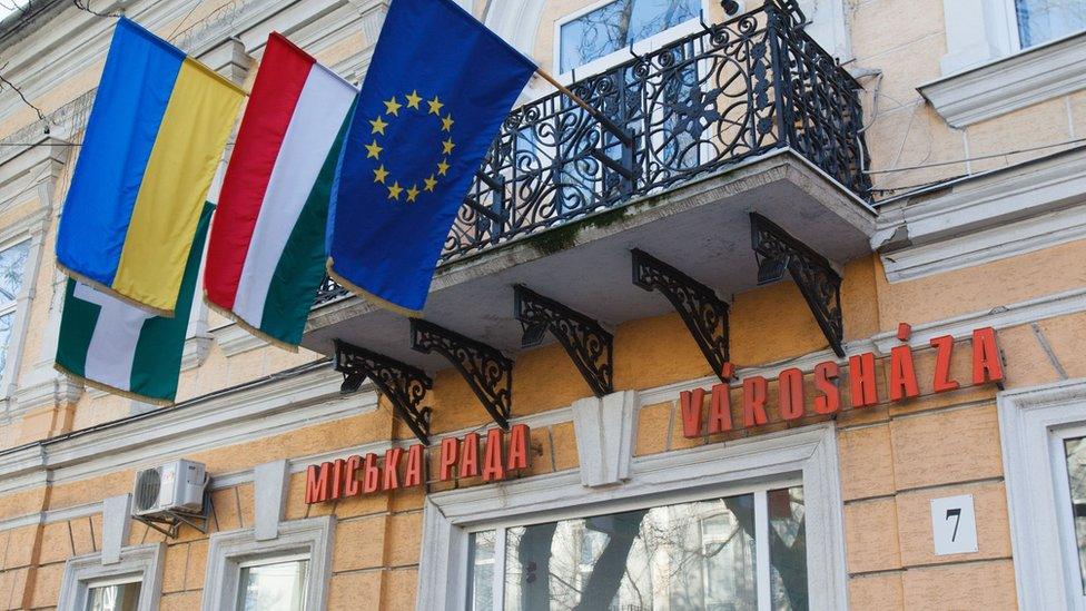 From left to right: Ukrainian, Hungarian and EU flags and inscriptions in Ukrainian and Hungarian on a city hall building of Berehove, western Ukraine. File photo