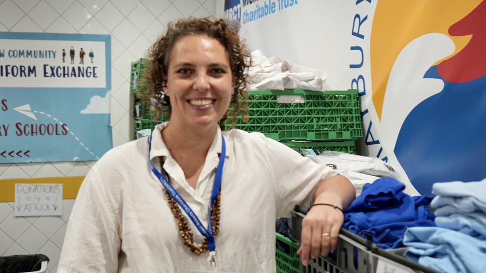 Fernanda Champness with baskets of school uniforms