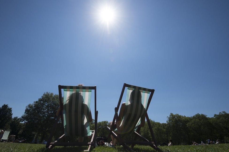 People sitting in deckchairs in the sun