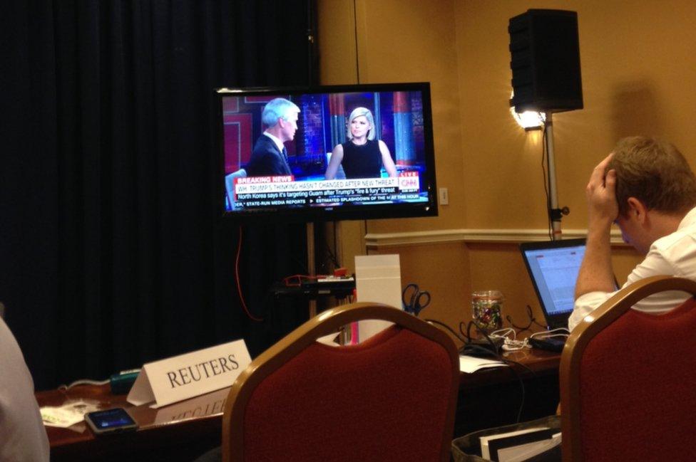 Pool reporters file their copy and watch CNN as the information is relayed to the American public