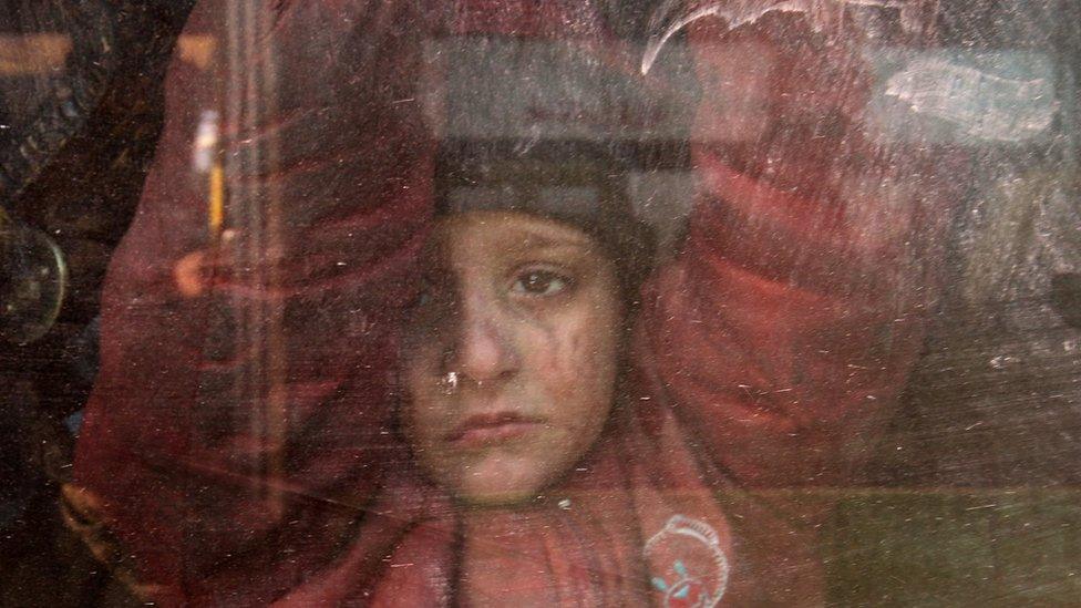 A boy rides a bus to be evacuated from a rebel-held sector of eastern Aleppo, Syria