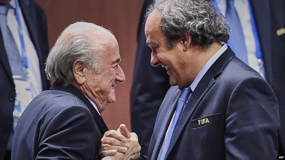 Sepp Blatter shakes hands with Michel Platini