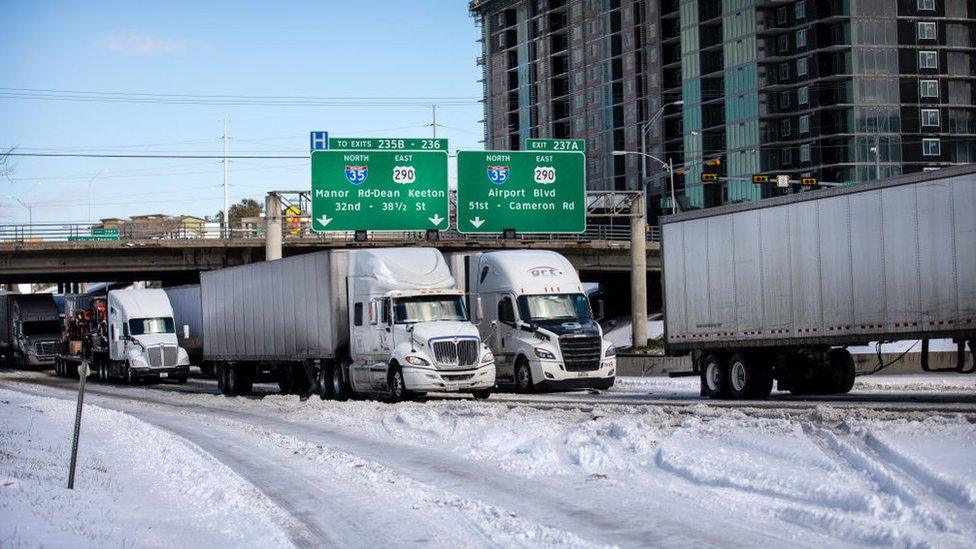 Trucks wait in traffic in Austin, Texas delayed by winter storm Uri