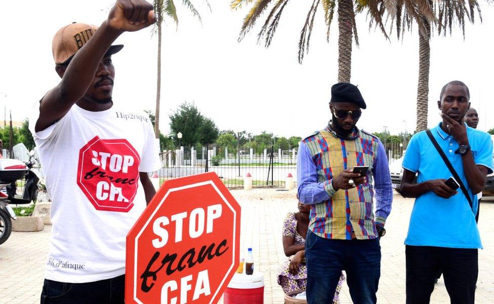 A man holds up his fist during an anti-colonial demonstration against the regional CFA franc in Dakar, Senegal -16 September 2017