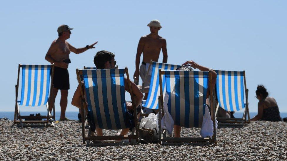 People on beach, in the sun