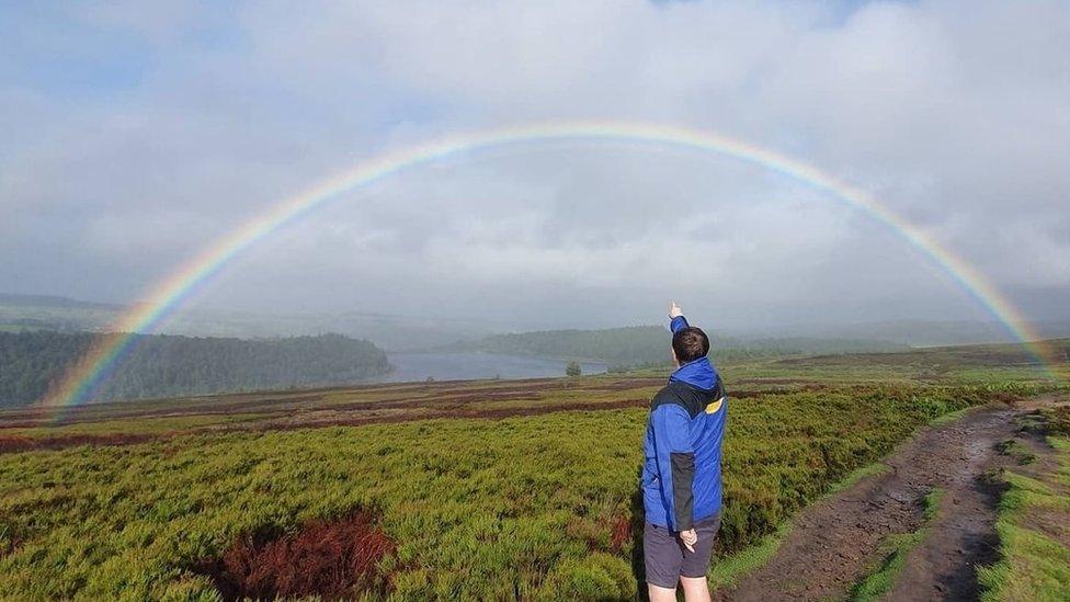 Craig Haimes pointing to the rainbow