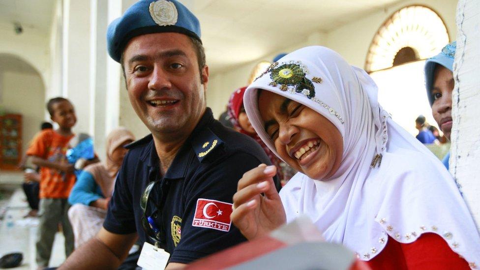 Turkish UN Police (UNPOL) officer Hakan Arslan shares a laugh with a girl at Dili Mosque Orphanage, Timor-Leste.