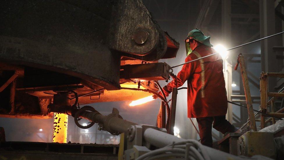 A worker tests a sample of steel as it is cast into a slab at the NLMK Indiana steel mill on March 15, 2018 in Portage, Indiana.