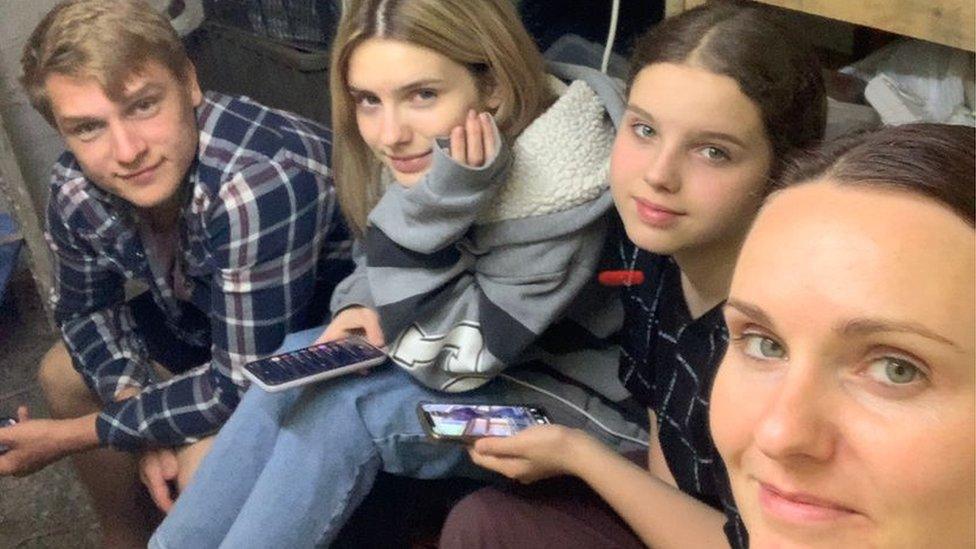 Iryna (right) with her daughters and family friend in a bunker in Lviv