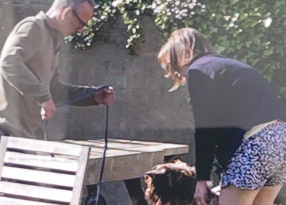 Photo of two people with a dog who police want to trace