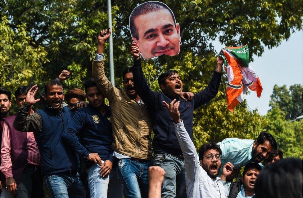 Congress Party members shout slogans against billionaire jeweller Nirav Modi