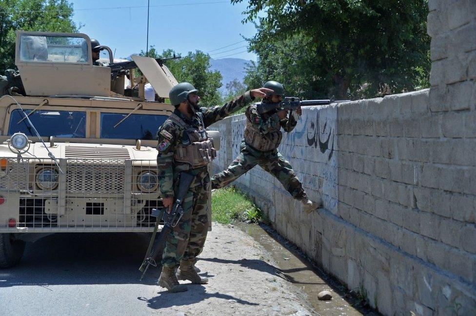 Members of Afghan security forces take their positions during an ongoing clash between Taliban and Afghan forces in Mihtarlam, the capital of Laghman Province, on 24 May, 2021