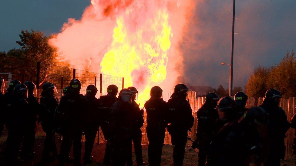 Police officers in riot gear at the Bloomfield walkway bonfire