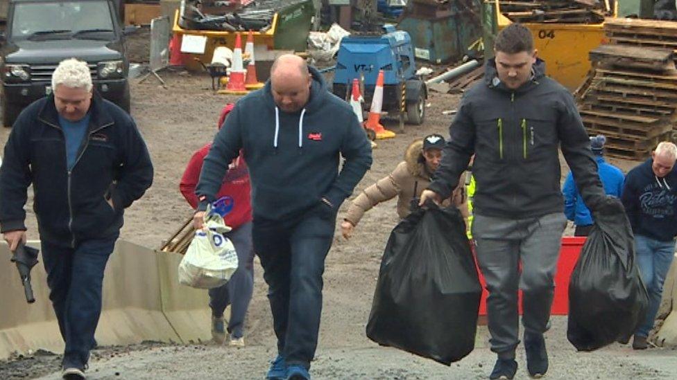 Workers leaving the meeting today