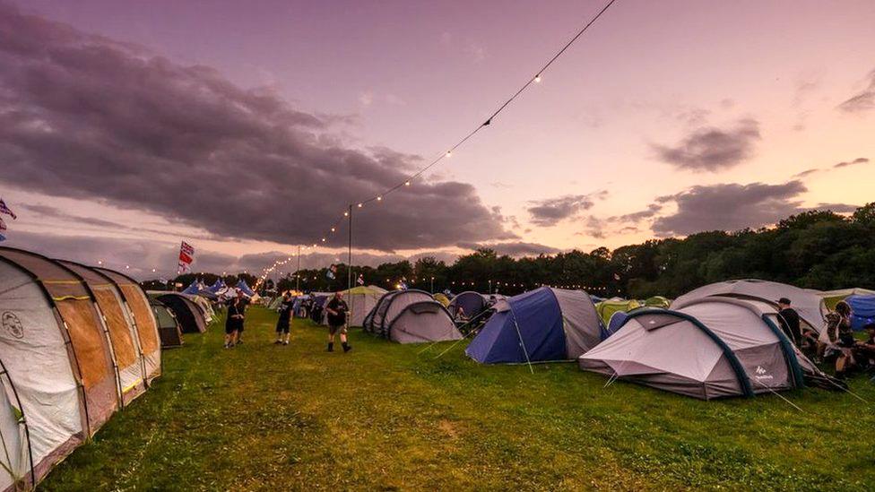 A number of tents installed in the campsite area