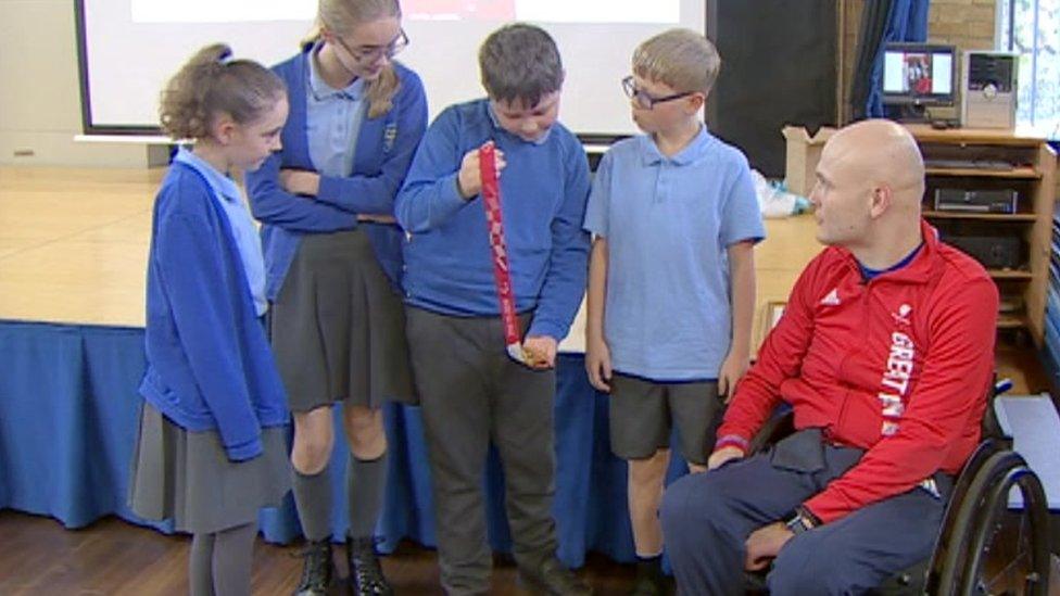 Jack Smith and pupils with his medal