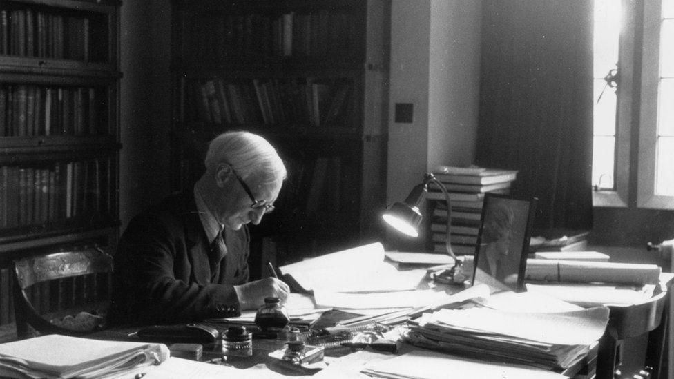 Sir William Beveridge at work in his office at University College, Oxford