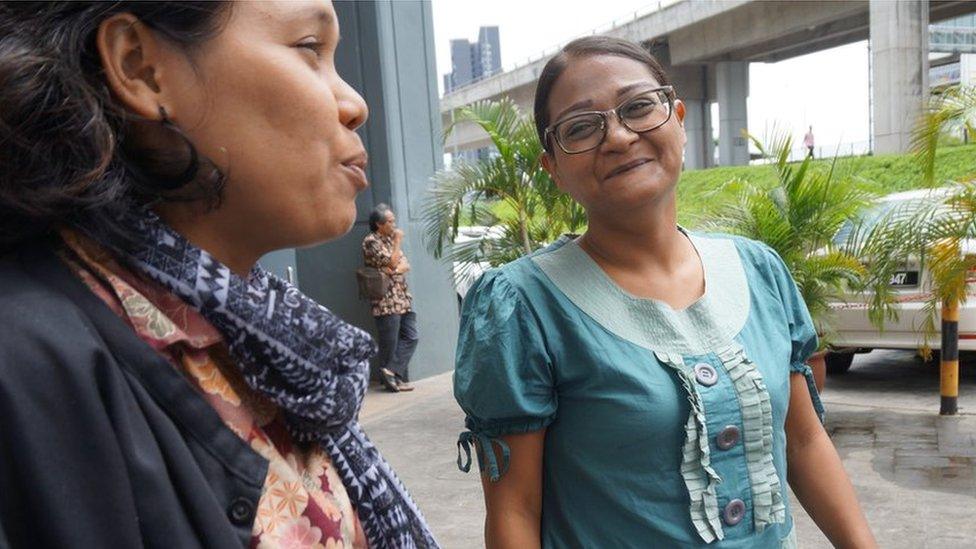 Yuki and another activist laugh over a cigarette